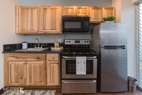 a kitchen with stainless steel appliances and wooden cabinets