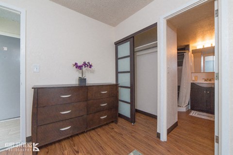 Kewalo Apartments living area with decor, closet, and bathroom doorway