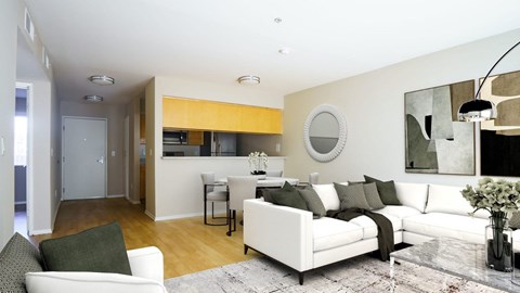 a living room and dining room with white furniture