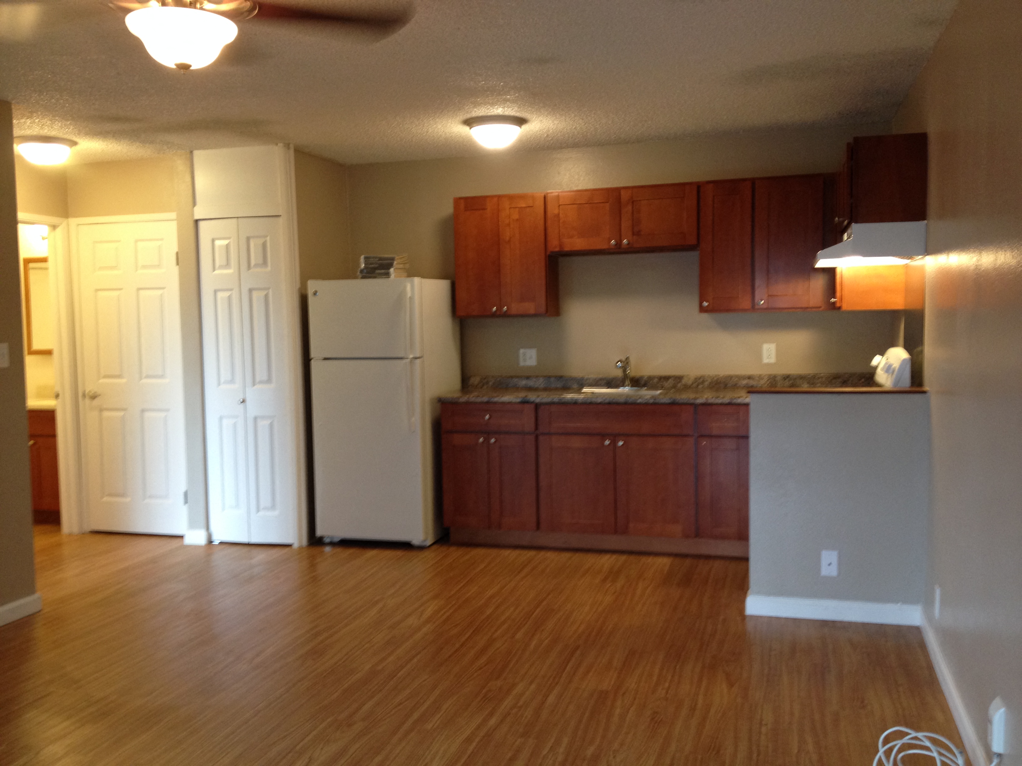 Coconut Inn kitchen area with refrigerator, cabinets, and counters
