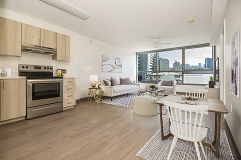 a living room with a kitchen and a dining table