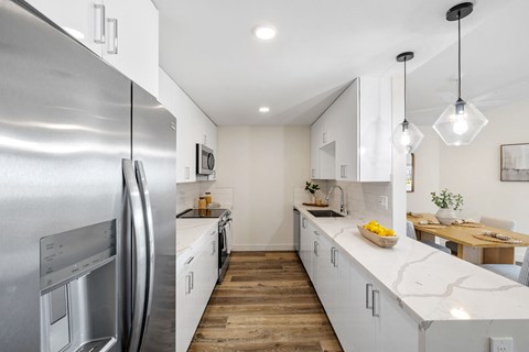 a kitchen with stainless steel appliances and white cabinets