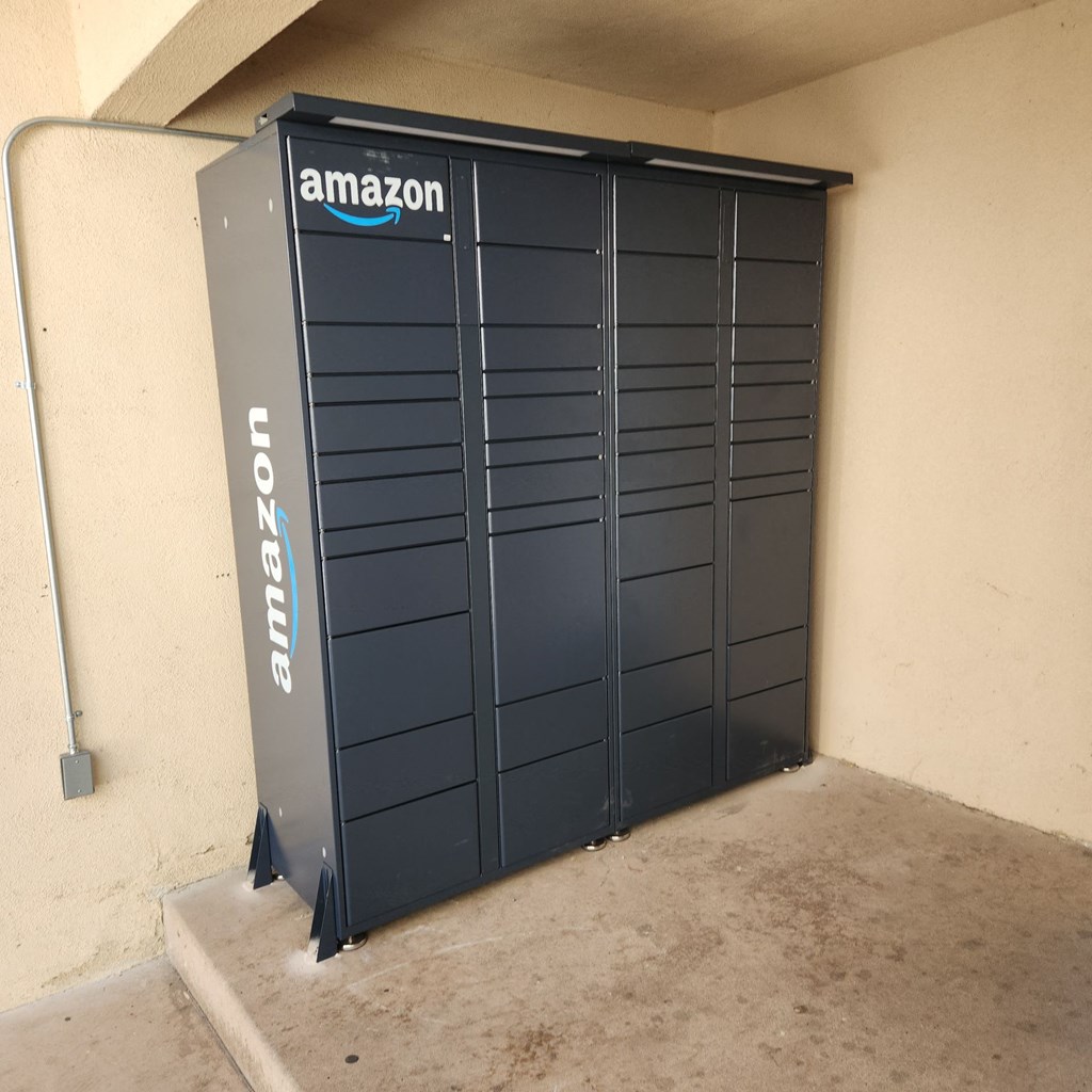 A large Amazon Locker unit is installed in a garage.