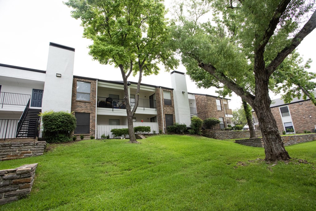 our apartments offer a green lawn and trees for residents to enjoy