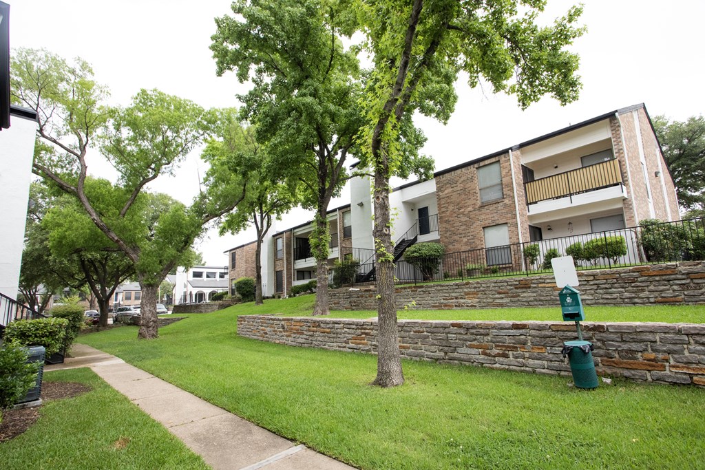 our apartments offer a green lawn and trees for residents to enjoy