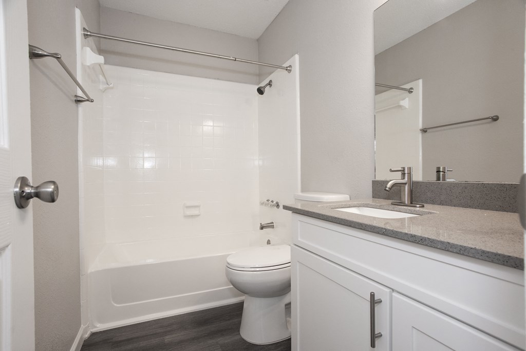 an empty bathroom with a sink toilet and shower