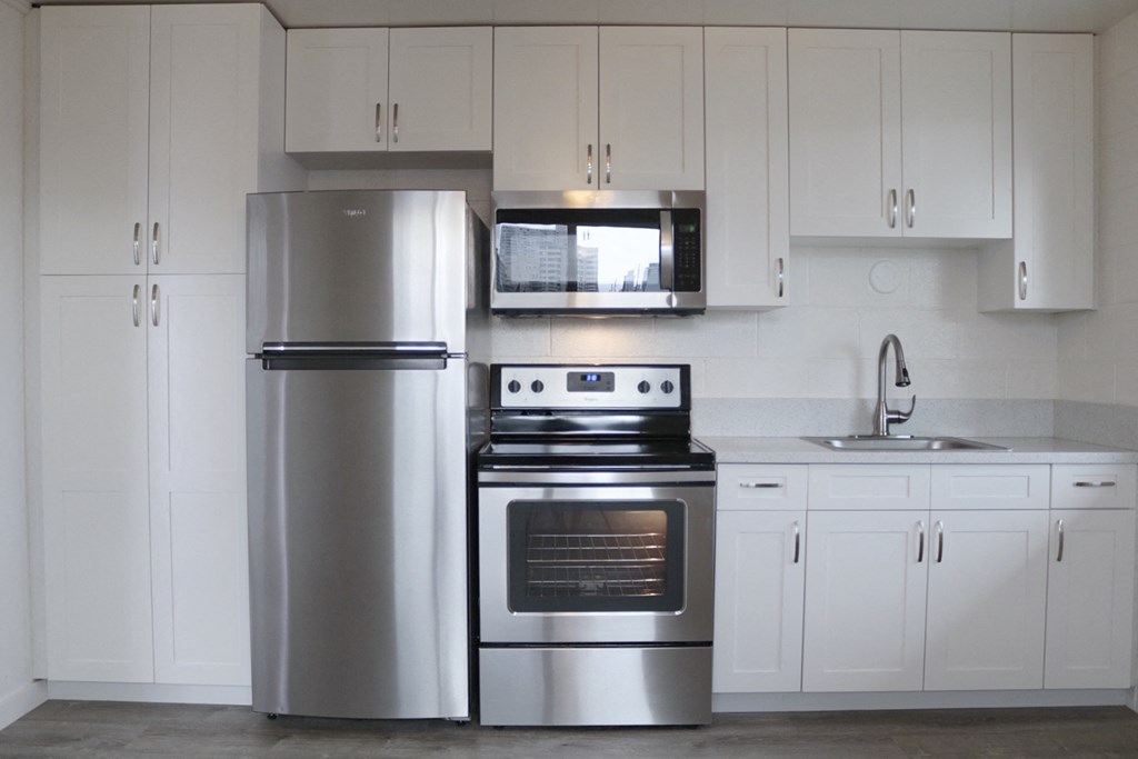 2048 South Beretania Street Apartments kitchen area with appliances and cabinets