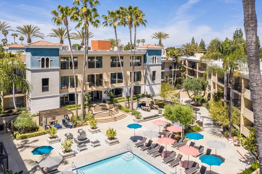 The Plaza at Sherman Oaks Luxury Apartments aerial view of resort style pool and patio with umbrellas - Photo Gallery