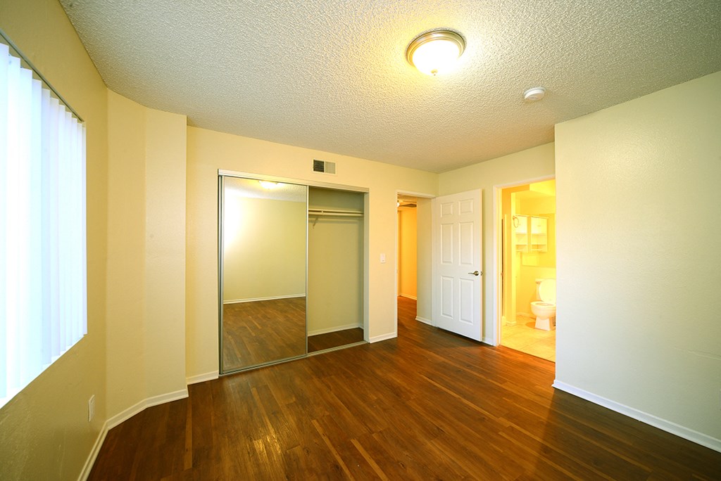 Monarch Terrace unfurnished bedroom with mirror closet