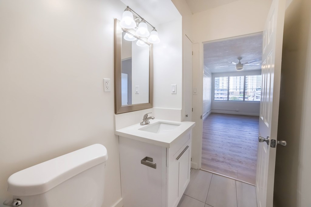 A white bathroom with a white tub and sink.