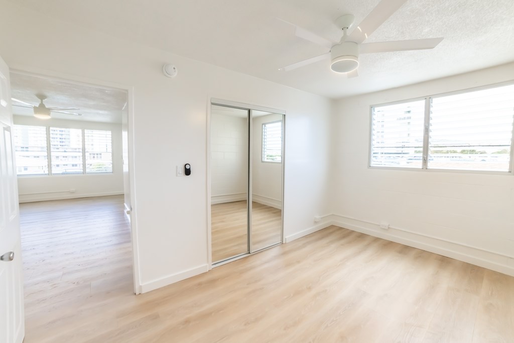 A room with a sliding door and a ceiling fan.