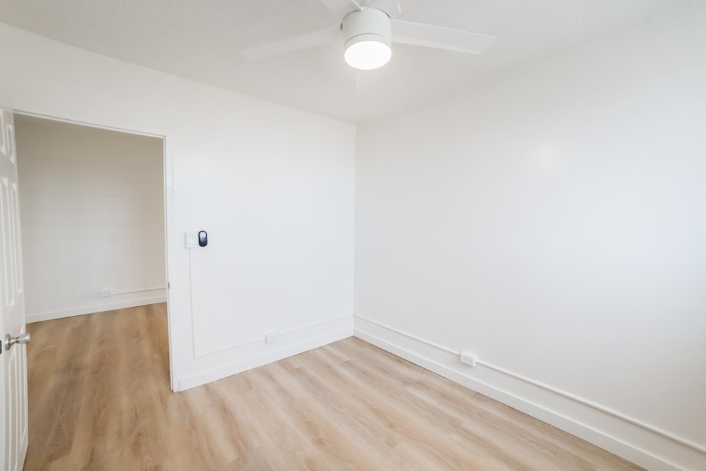 A room with a white ceiling and a white door.