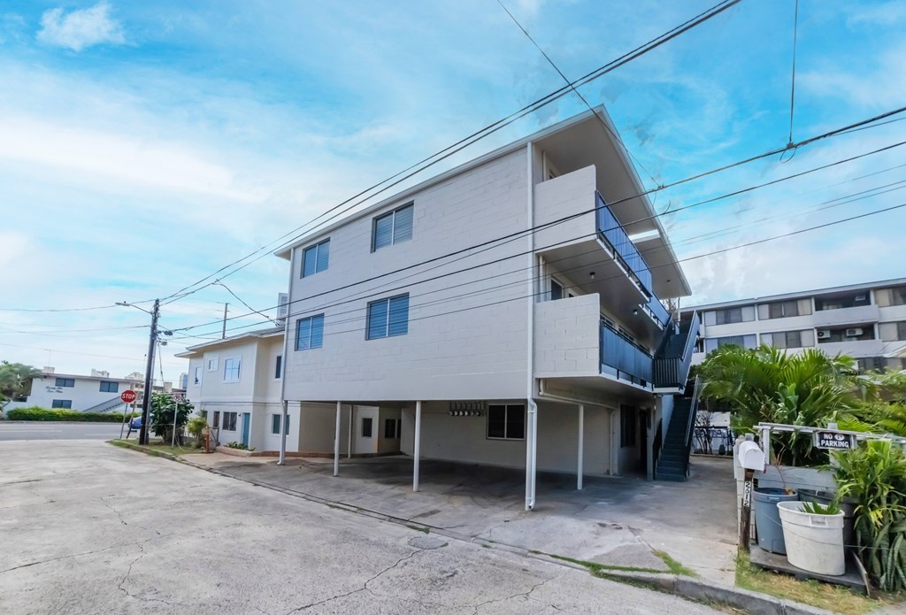 A two-story residential building with a garage on the ground floor.