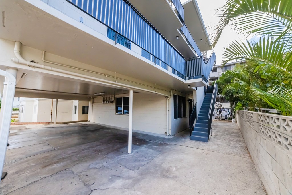 A concrete courtyard with a staircase leading to a building.