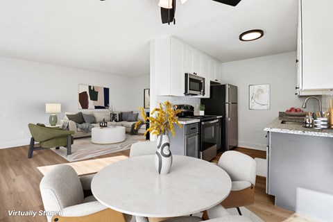 A modern kitchen with a dining table and chairs.