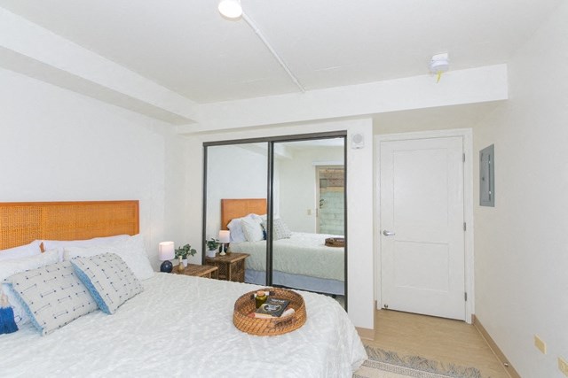 Kanekapolei Collection Bedroom with mirror doored closets and decor