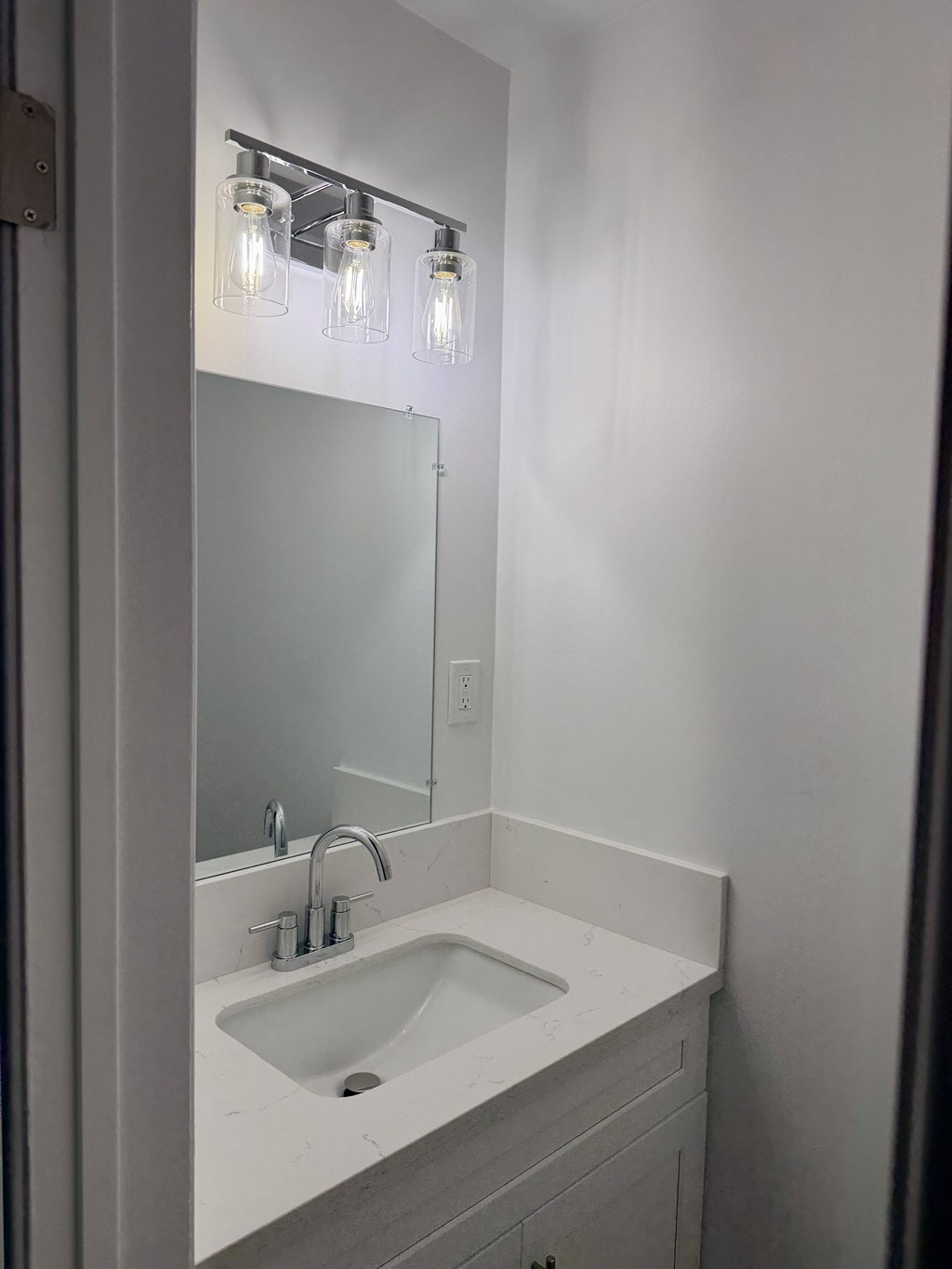 A bathroom sink with a mirror above it.