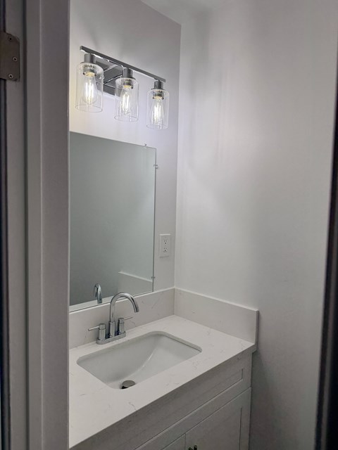 A bathroom sink with a mirror above it.