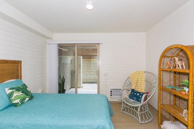 Kanekapolei Collection Bedroom with mirror doored closets and decor