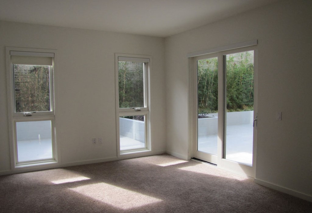 Mayfair Residences living area with tall windows and sliding doors