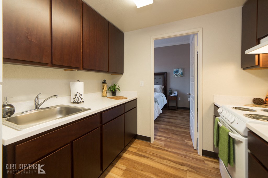 Wakea Garden Apartments kitchen area with decor, appliances, and cabinets 