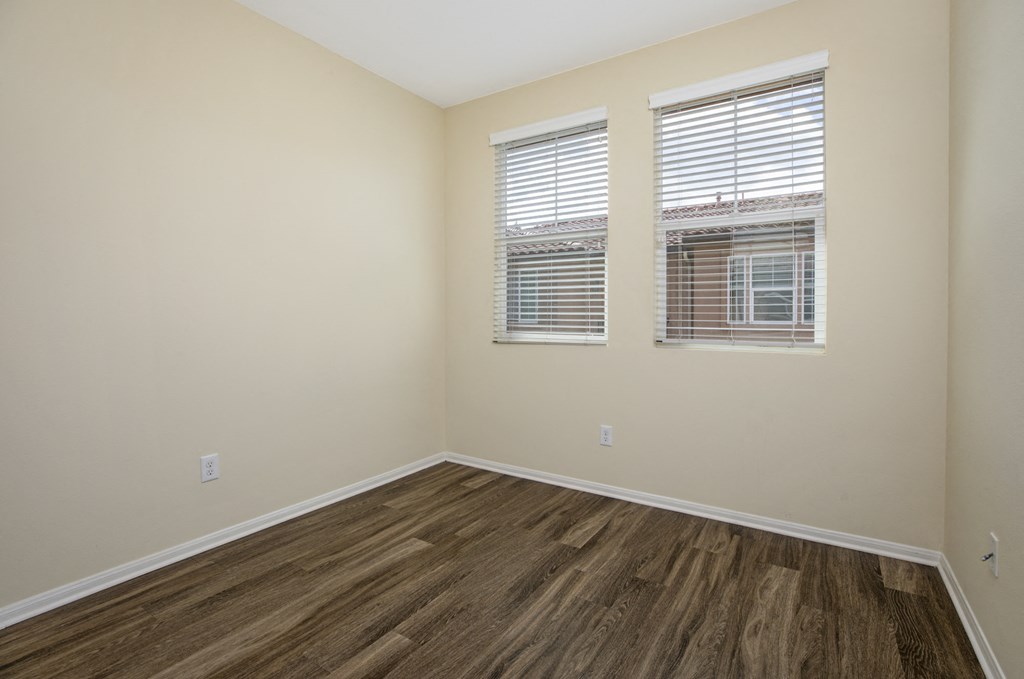 Parkside Villas unfurnished bedroom with wooden floors and window