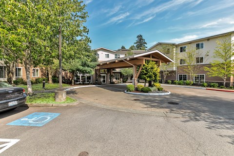 the enclave at green valley apartments entrance to parking lot with apartment buildings
