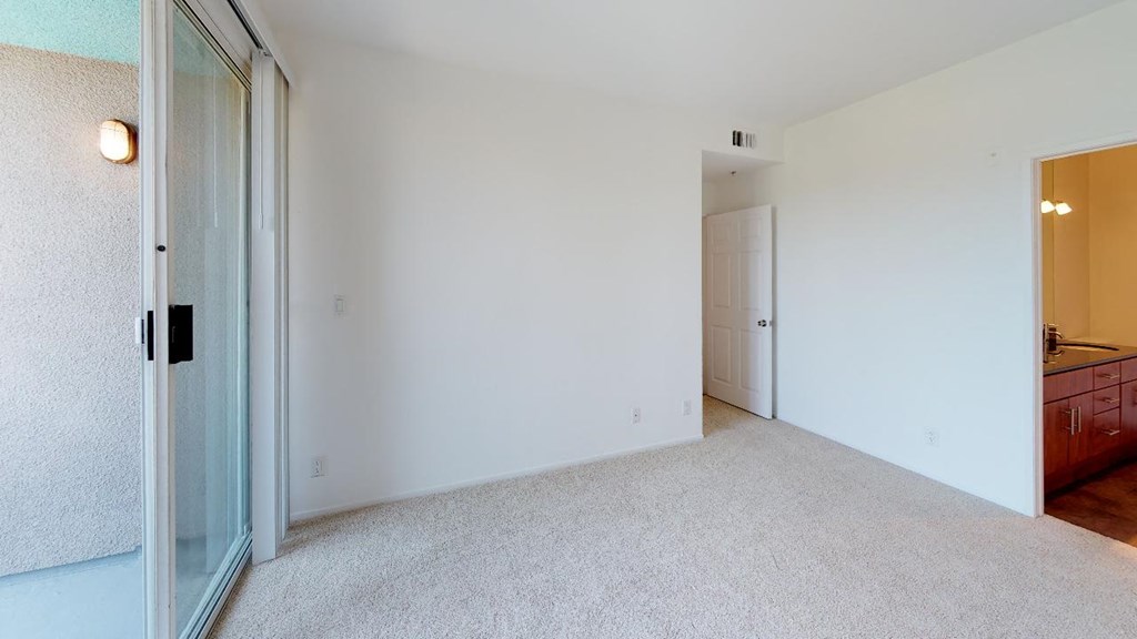 5015 Clinton Apartments unfurnished living room with sliding doors to patio