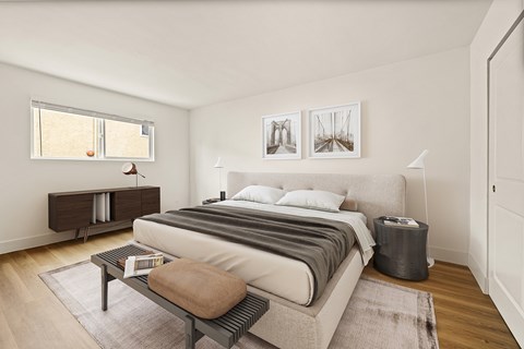 A bedroom with a large bed and a nightstand.