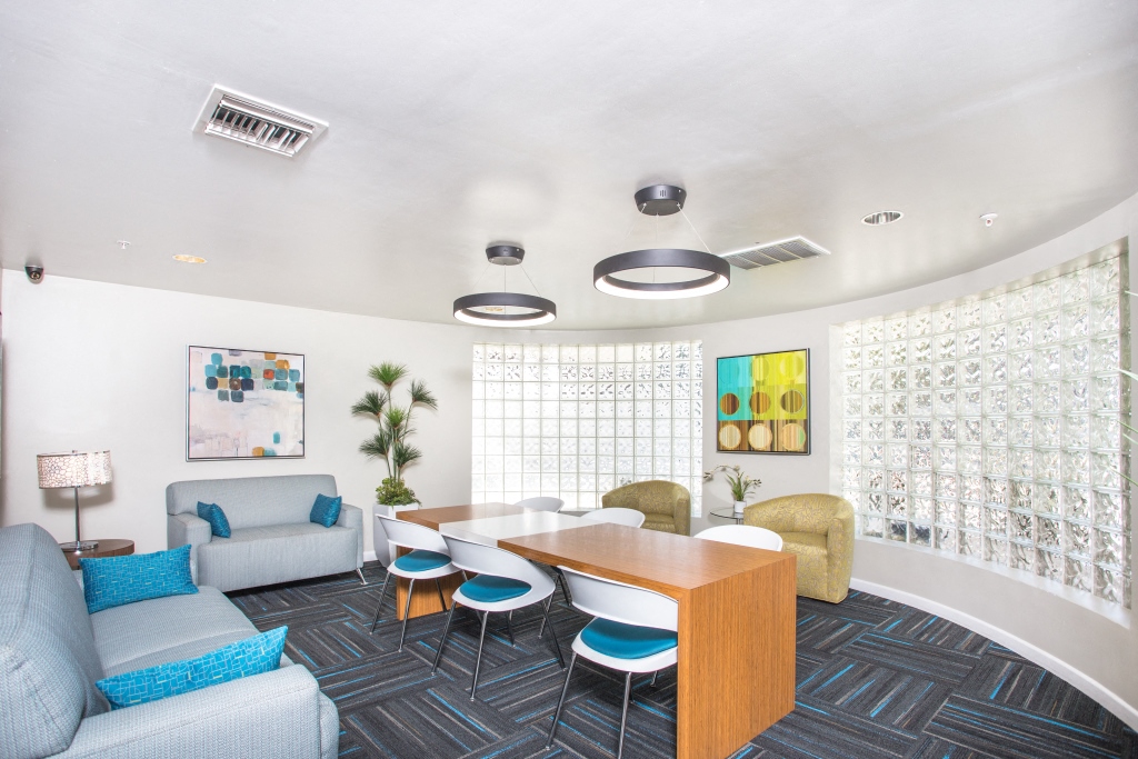 a living room with couches chairs and a table