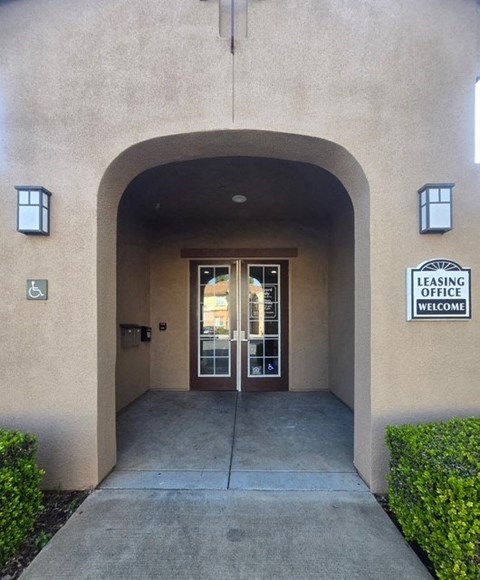 The entrance to a leasing office with a sign that reads "Welcome".