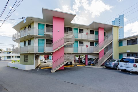 A multi-story building with a pink staircase.
