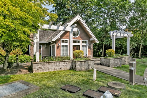 the front of a house with a yard and a patio