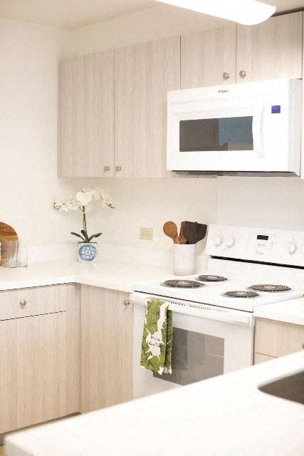 Kanekapolei Collection Kitchen area with appliances, cabinet, and counters
