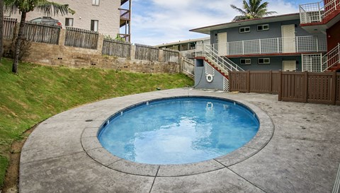 a resort style pool is in the backyard of an apartment building