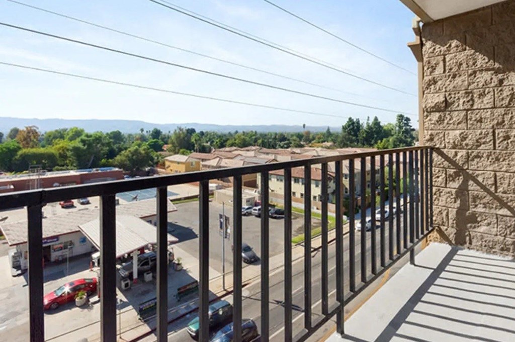 a balcony with a view of a parking lot