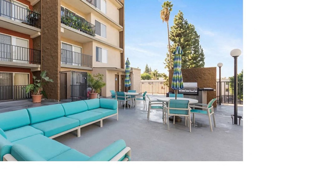 a rendering of a patio with blue couches and tables