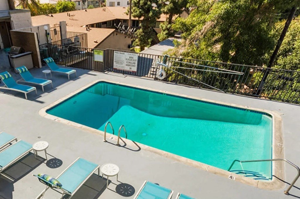 a pool is shown at a hotel with blue chairs