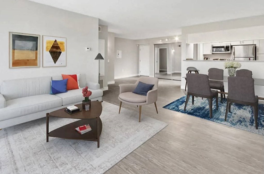 a living room and dining room area with a couch and a table