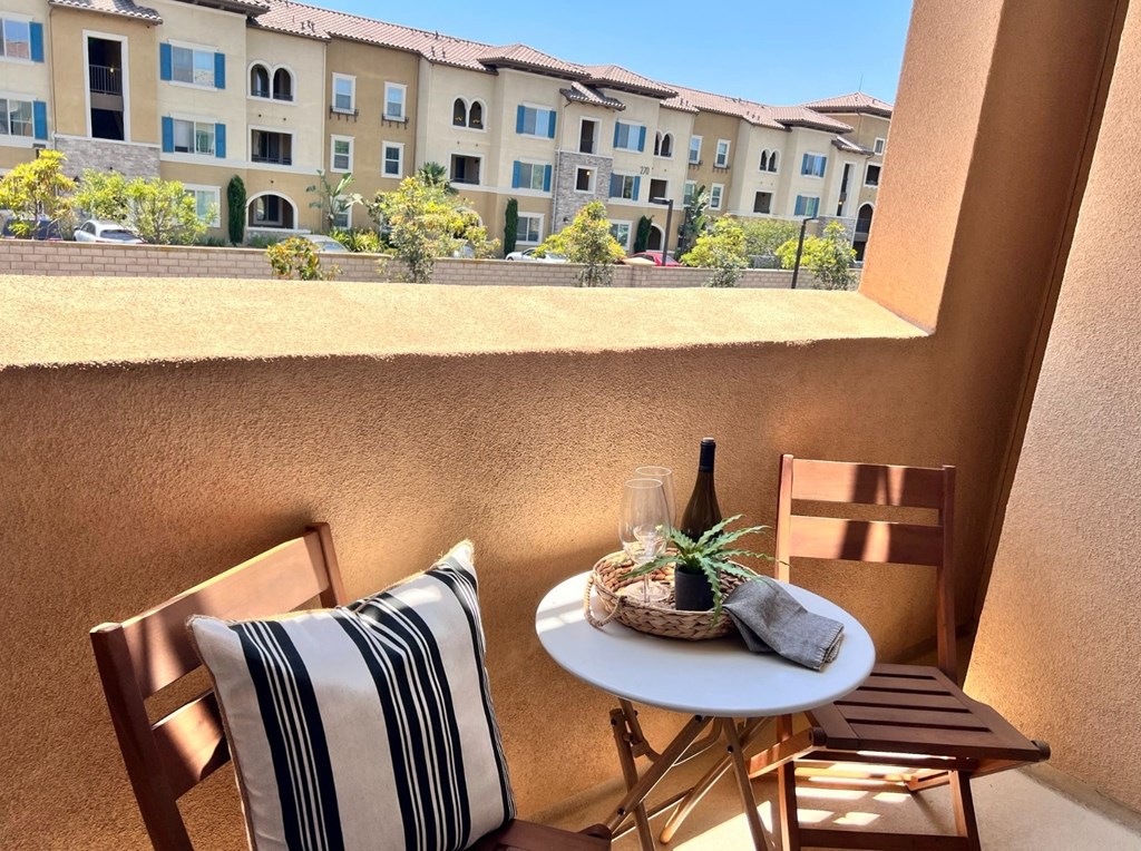 a patio with a table and chairs and a window