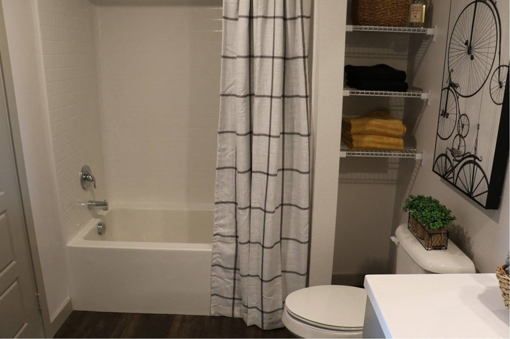 a bathroom with a shower and a toilet and a shower curtain