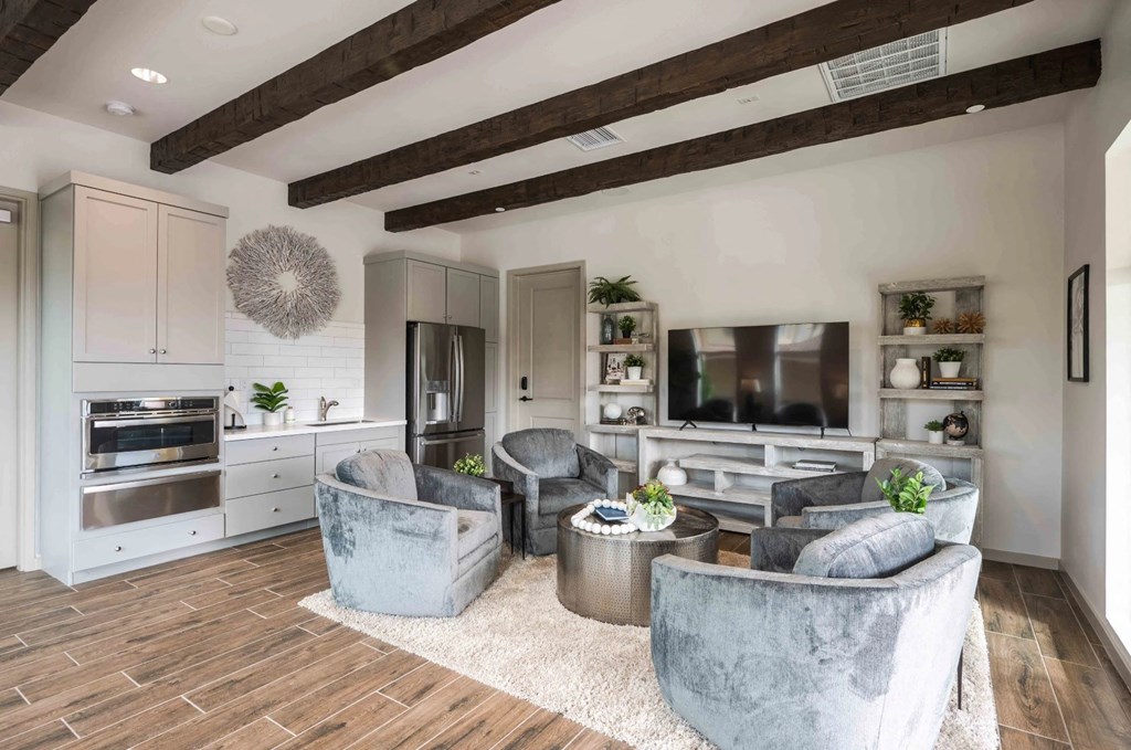 a living room with couches and chairs and a tv