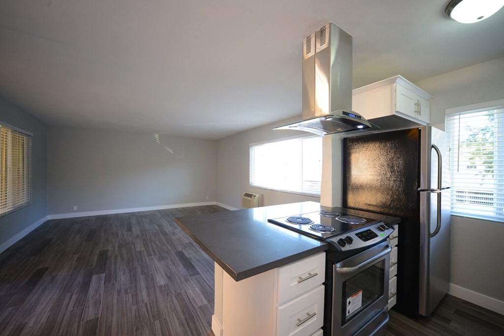 Atrium Court kitchen area with appliances and unfurnished living room