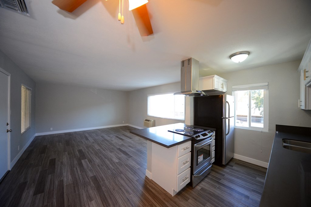 Atrium Court kitchen area with appliances and unfurnished living room