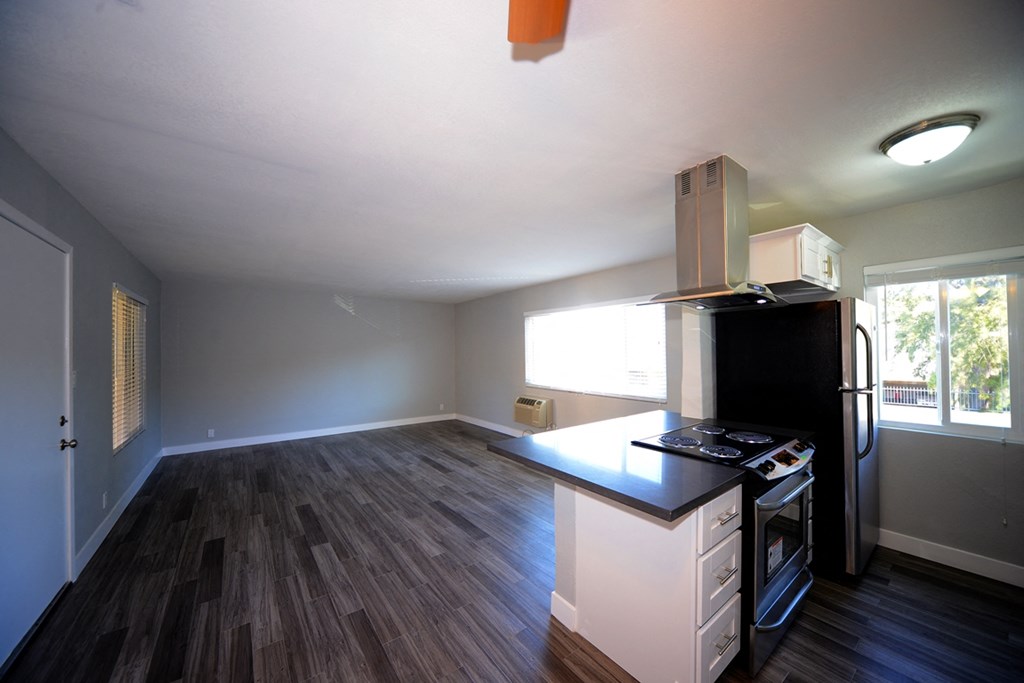 Atrium Court kitchen area with appliances and unfurnished living room