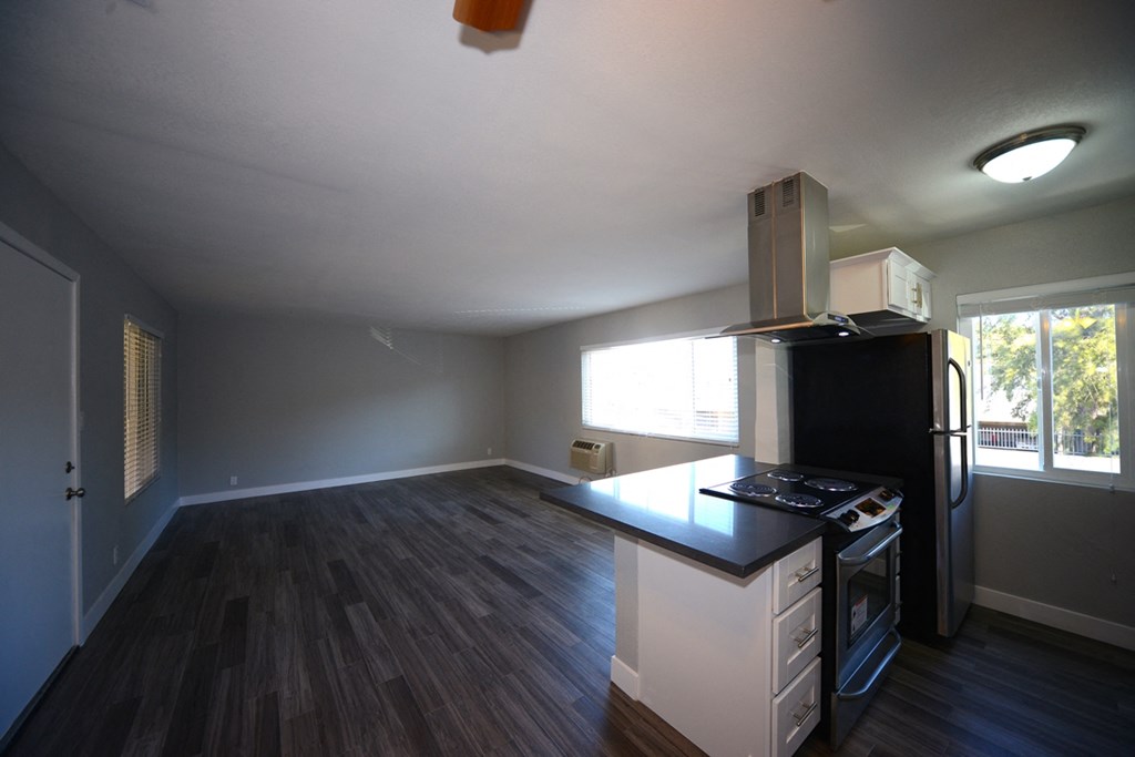 Atrium Court kitchen area with appliances and unfurnished living room