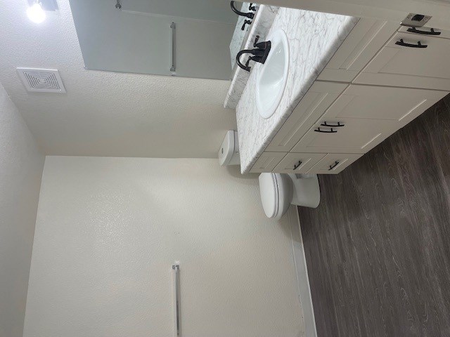 A white bathroom with a toilet and sink.
