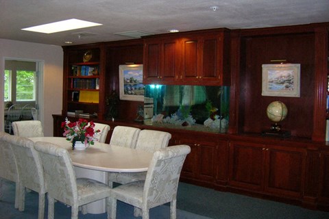 a dining room with a fish tank and a table