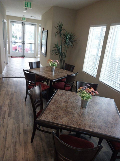 A dining room with a table set for two.