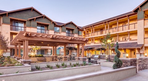 a rendering of the exterior of a hotel with a courtyard